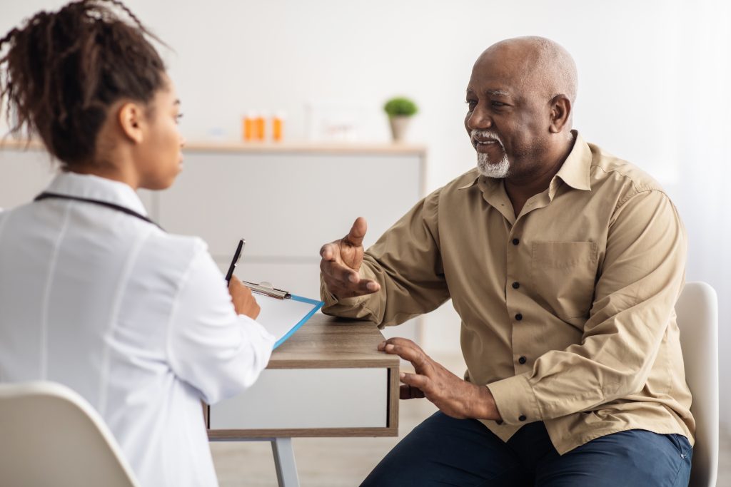 A man talking with a workers comp case manager in Michigan.